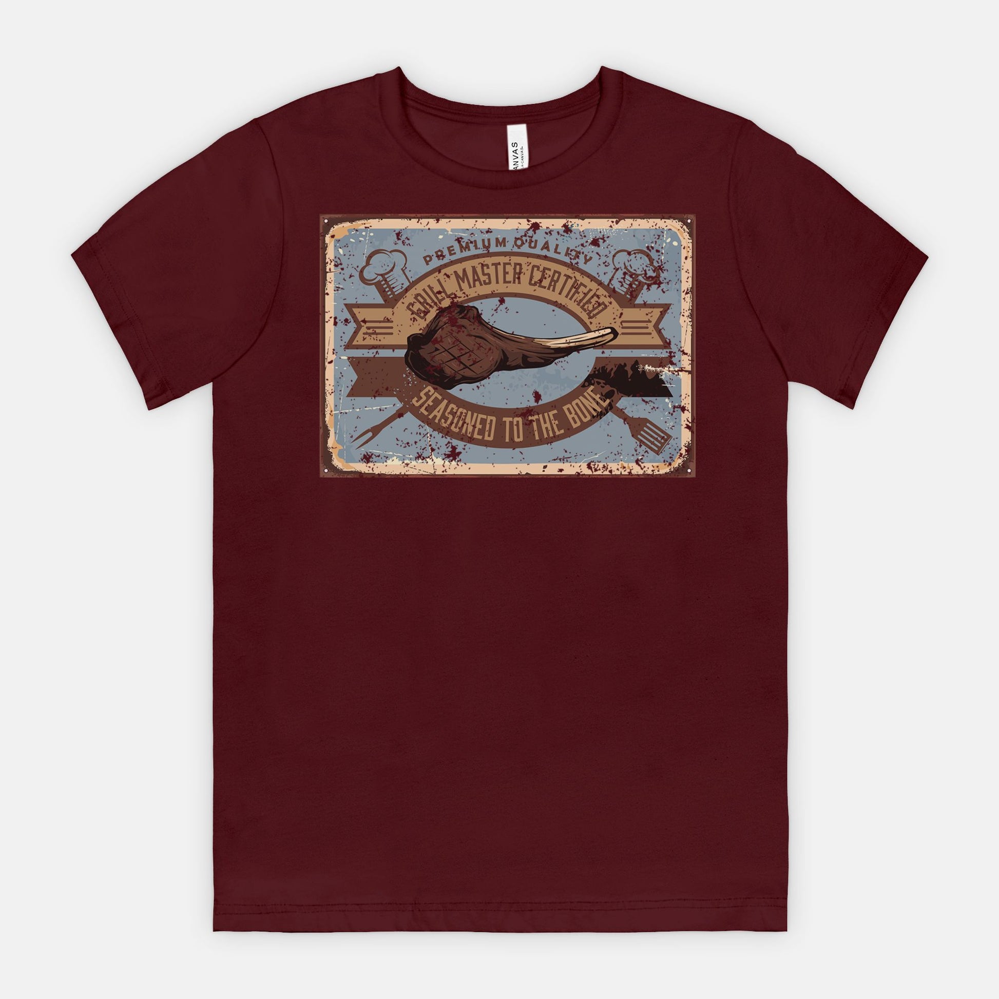 Maroon t-shirt with a graphic Grill Master Certified - Seasoned to the Bone on a white background