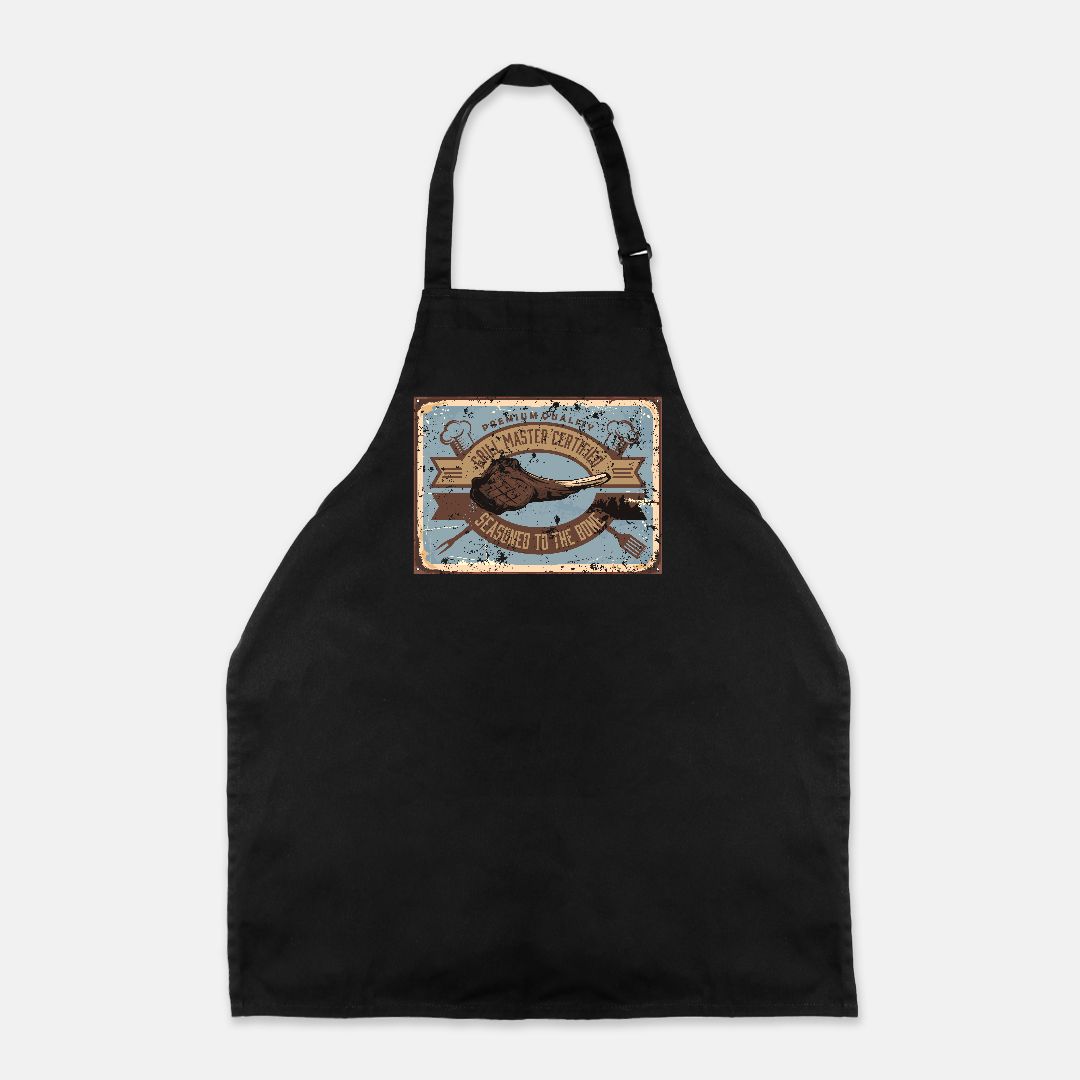 Black apron with a decorative patch that says "Certified Grill Master - Seasoned to the Bone" on a white background