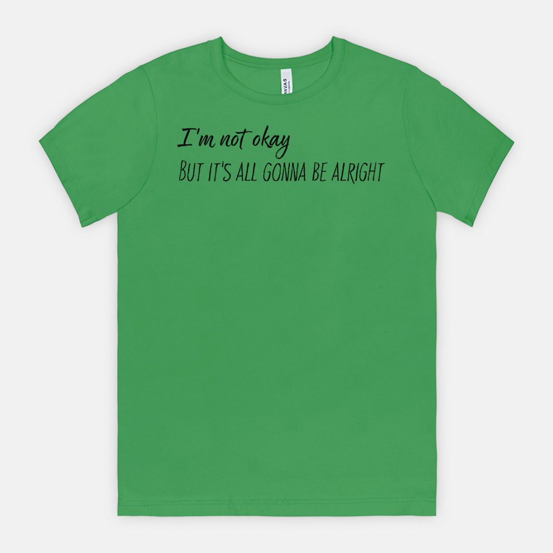 Green t-shirt with text 'I'm not okay BUT IT'S ALL GONNA BE ALRIGHT' on a white background