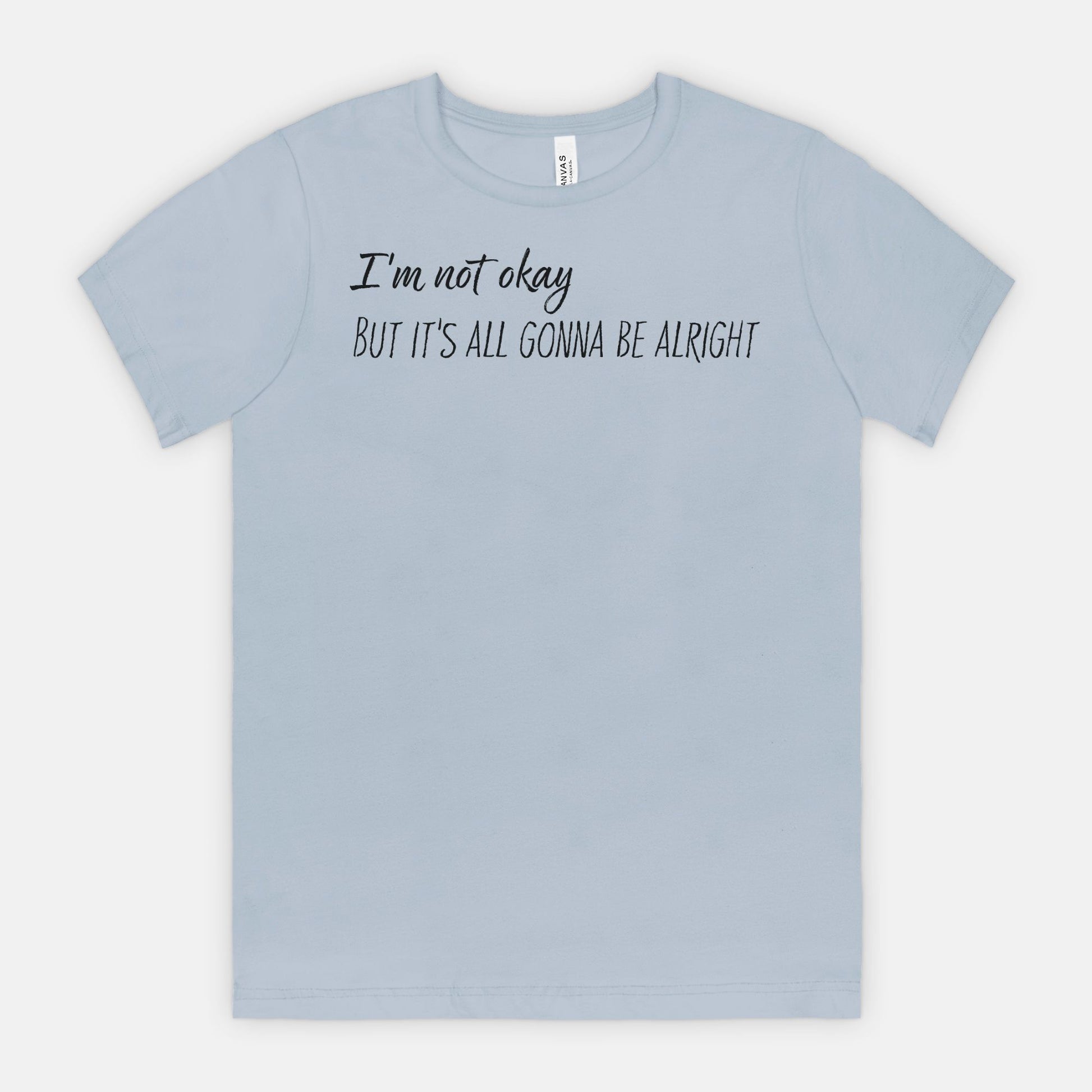 Light blue t-shirt with text, "I'm not okay but it's all gonna be alright" on a white background