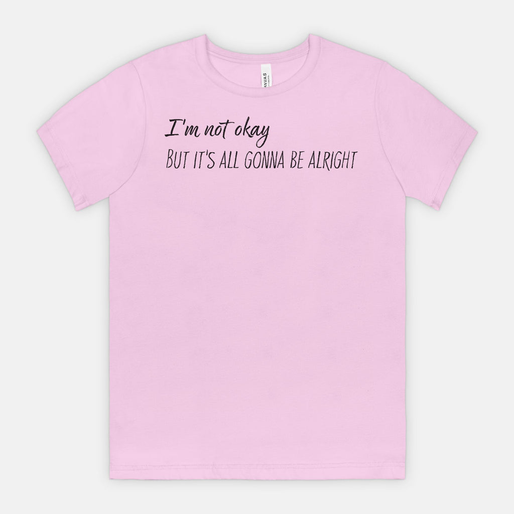 Lilac t-shirt with text 'I'm not okay, but it's all gonna be alright' on a white background