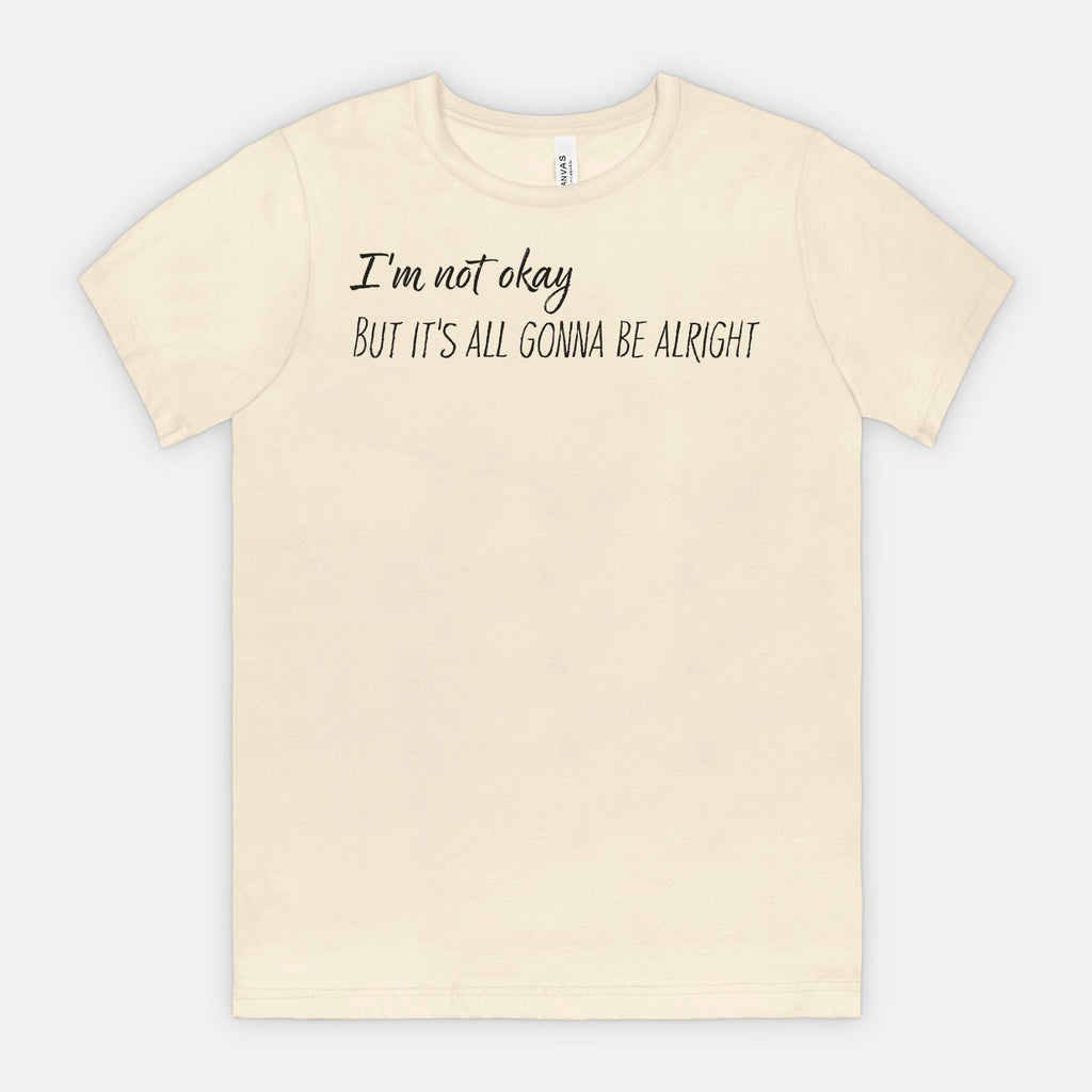 Natural t-shirt with text 'I'm not okay, but it's all gonna be alright' on a white background