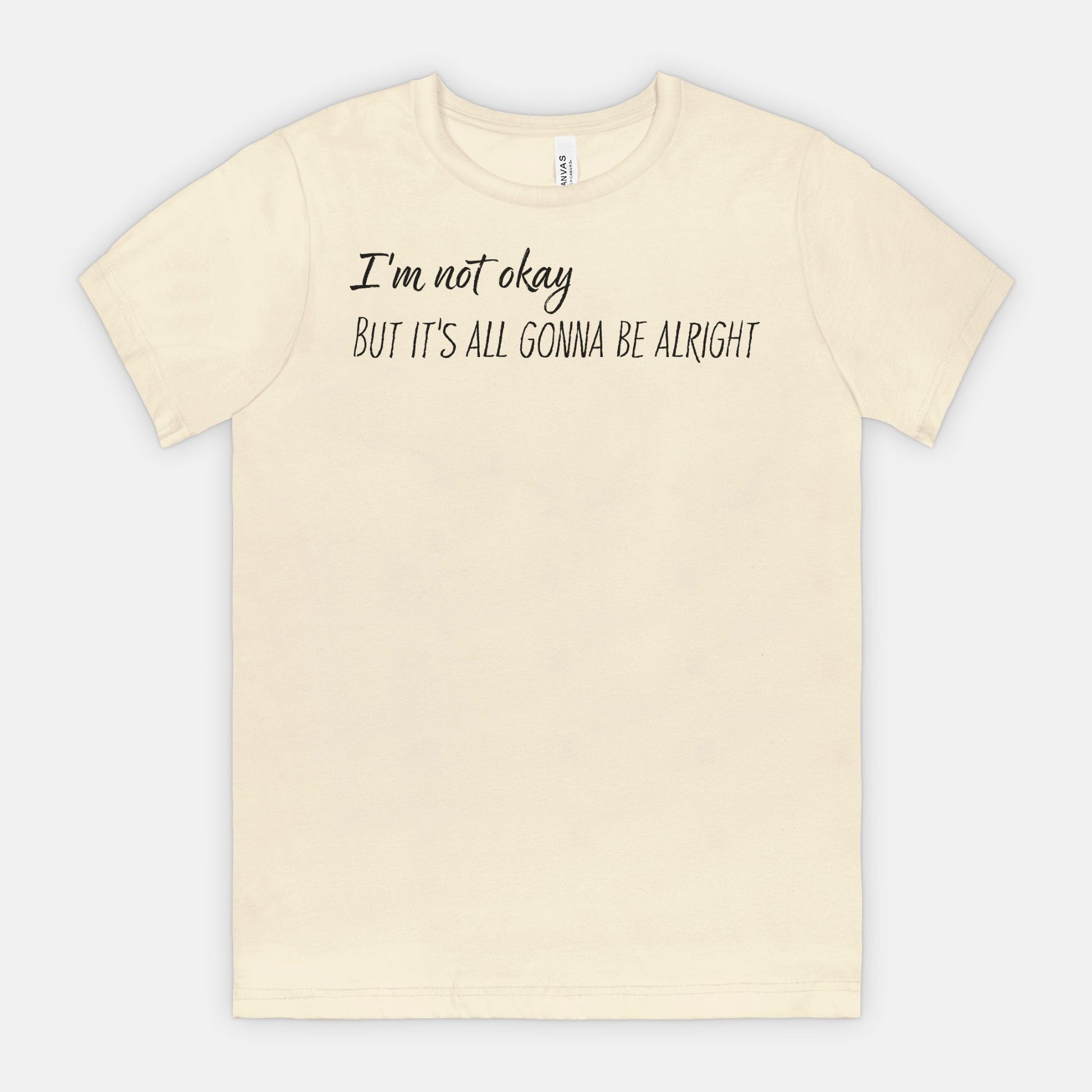 Natural t-shirt with text 'I'm not okay, but it's all gonna be alright' on a white background