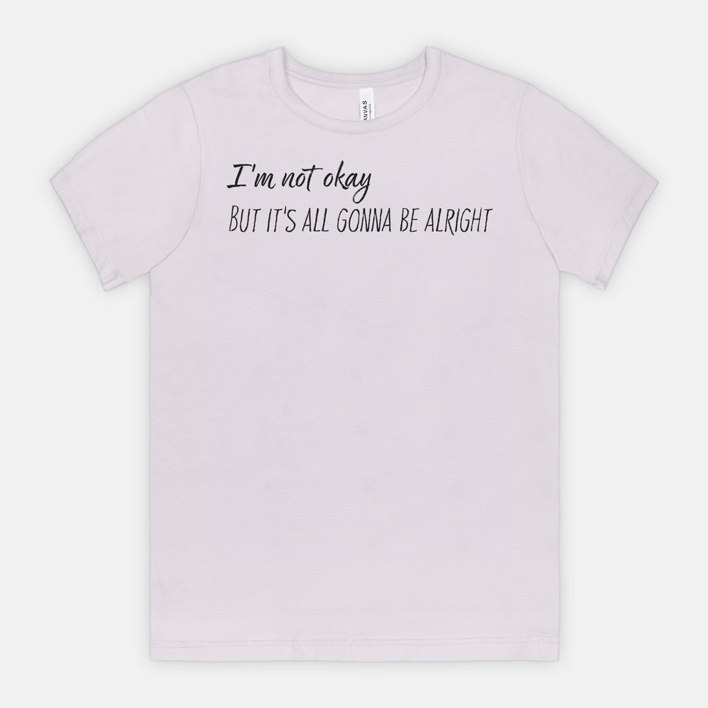Light purple t-shirt with text 'I'm not okay, but it's all gonna be alright' on a white background