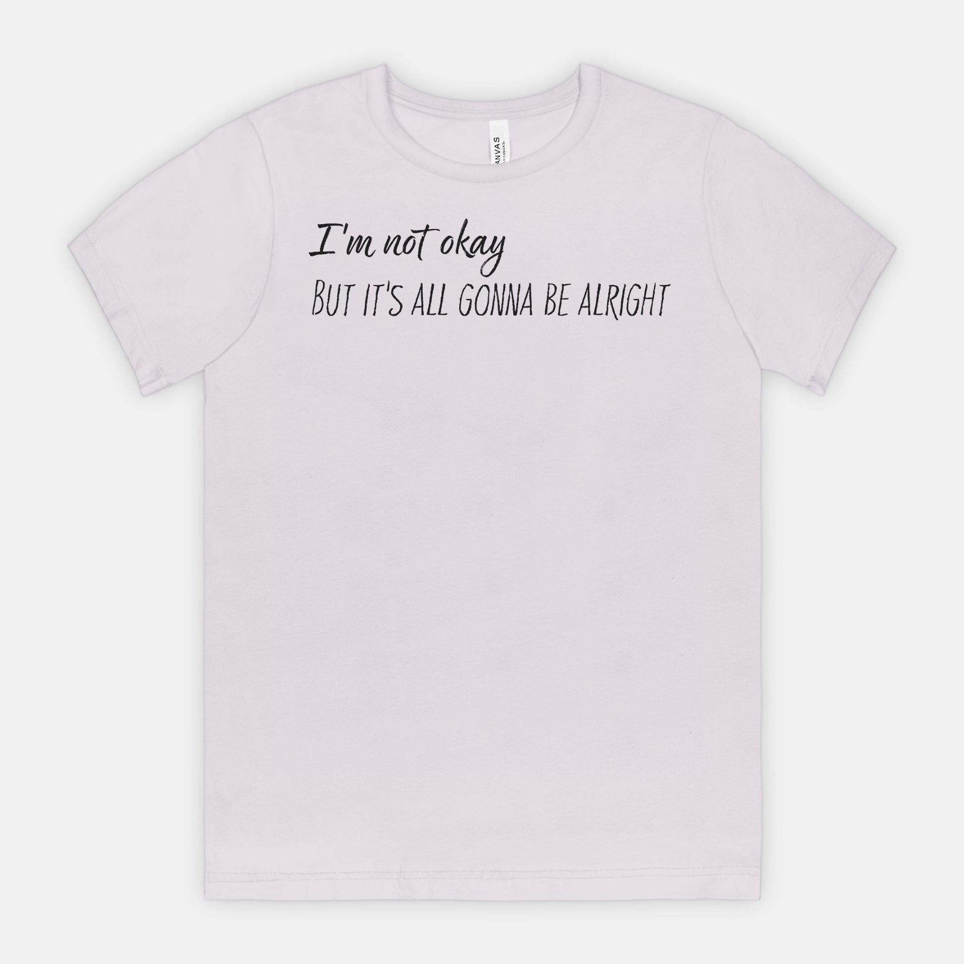 Light purple t-shirt with text 'I'm not okay, but it's all gonna be alright' on a white background