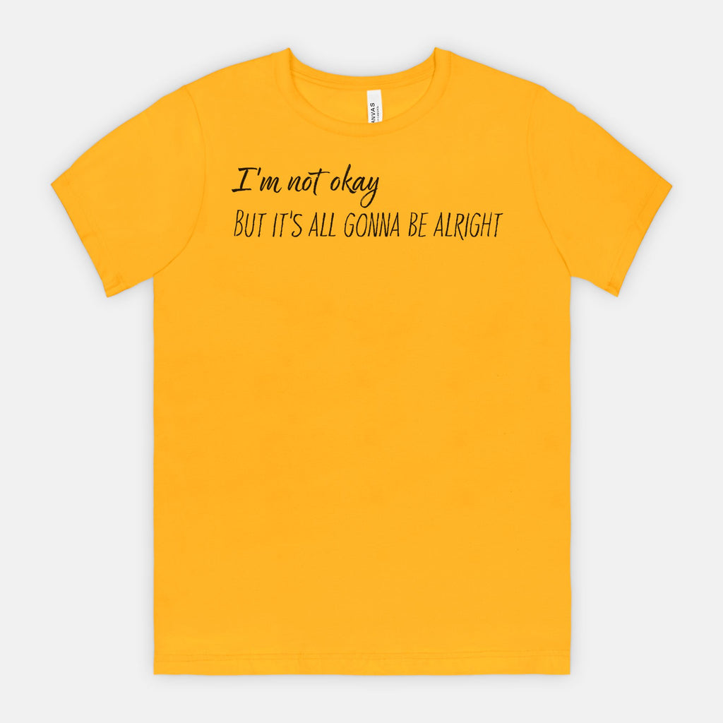Yellow t-shirt with text 'I'm not okay But it's all gonna be alright' on a white background