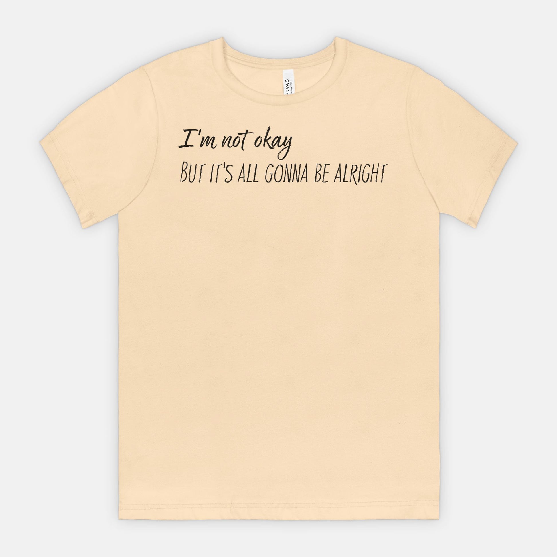 Soft Cream t-shirt with text 'I'm not okay, but it's all gonna be alright' on a white background