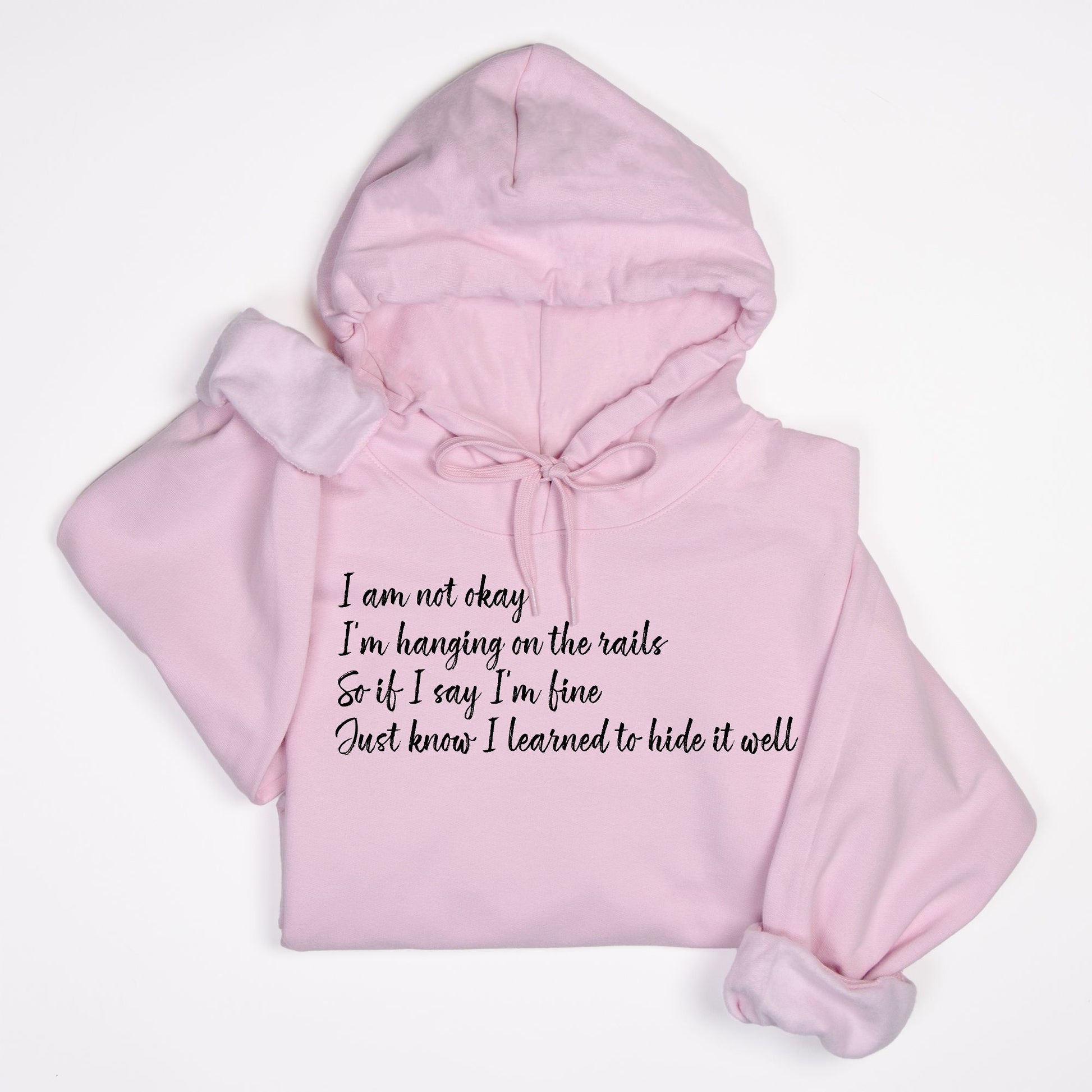 Pink hoodie with text "im not okay hanging on the rails" on a white background