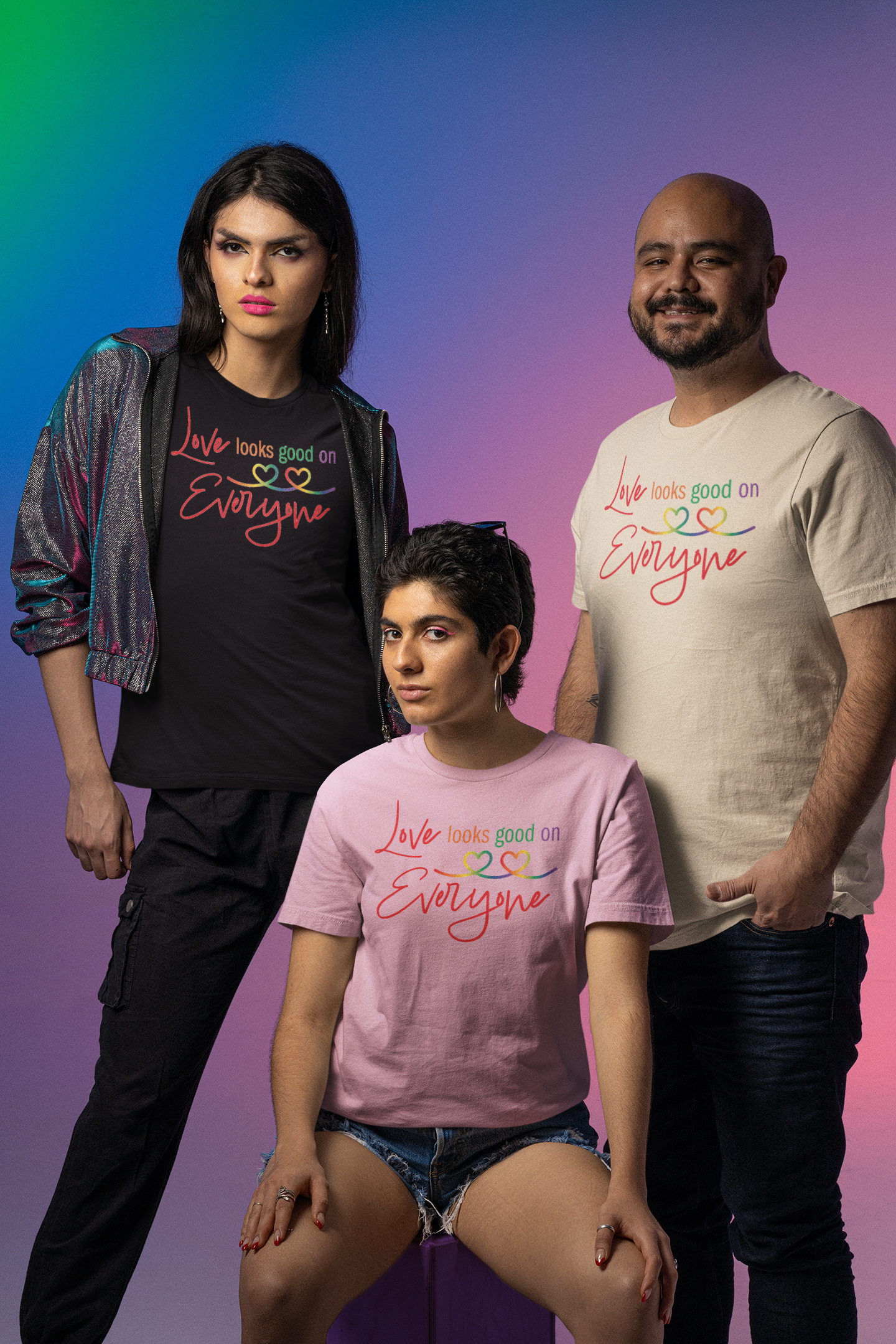 Three people wearing t-shirts with a colorful text "Love Looks Good on Everyone".