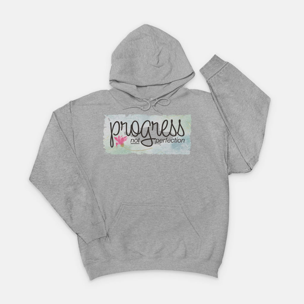 Gray hoodie with 'progress not perfection' text on a white background