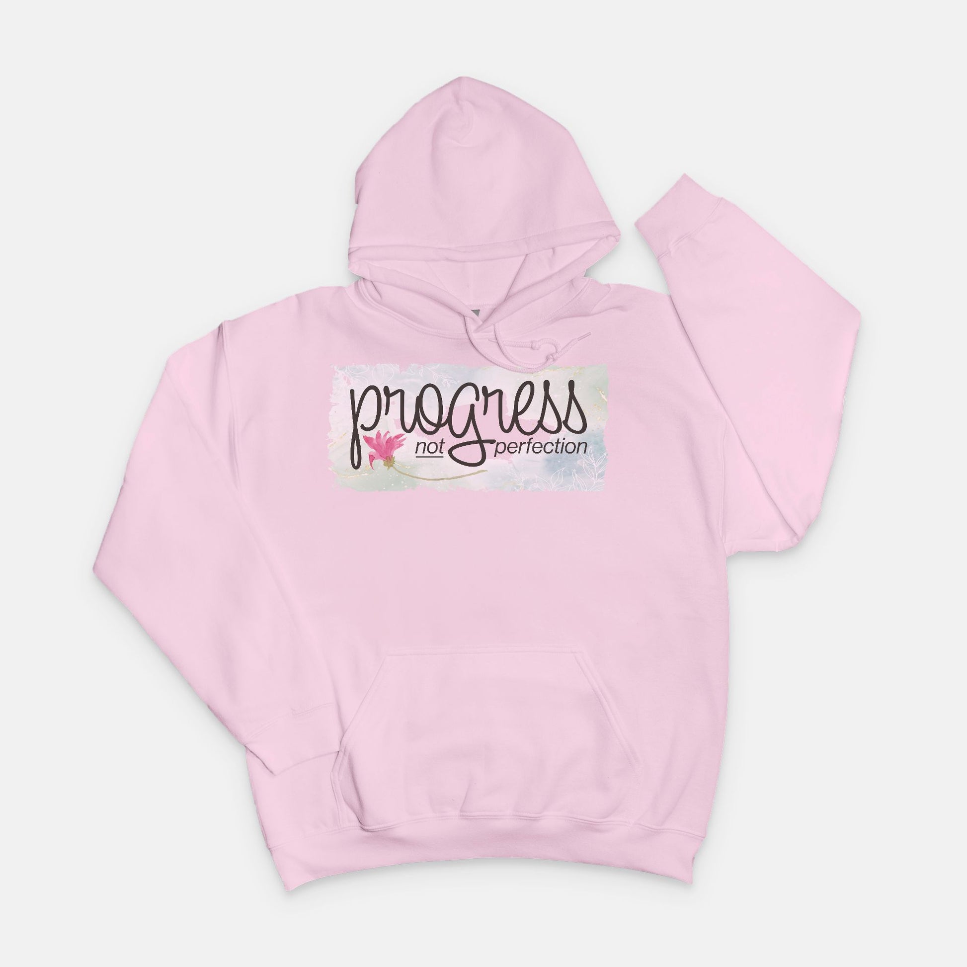 Pink hoodie with 'progress not perfection' text on a white background