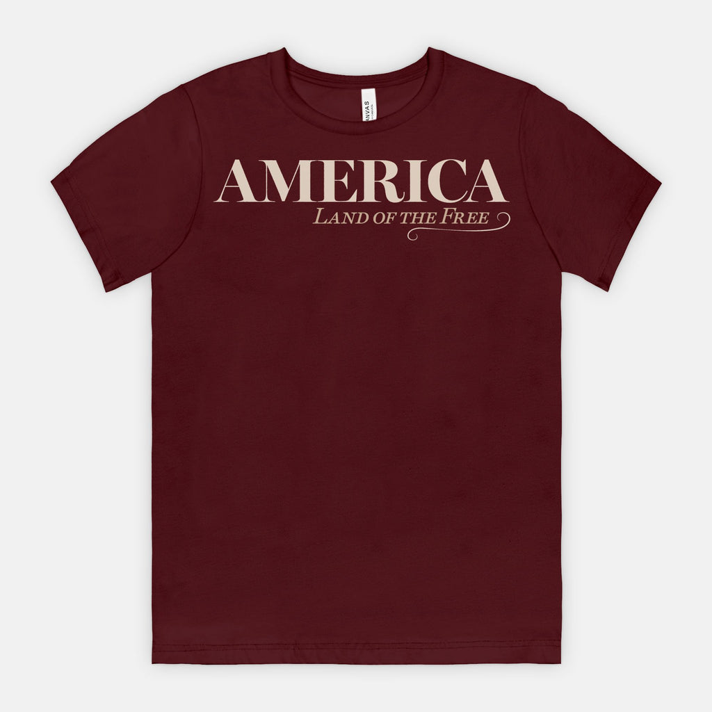 Vintage America Land of the Free patriotic typography design on Bella Canvas 3001 Maroon T-shirt by Red Rock Chaos