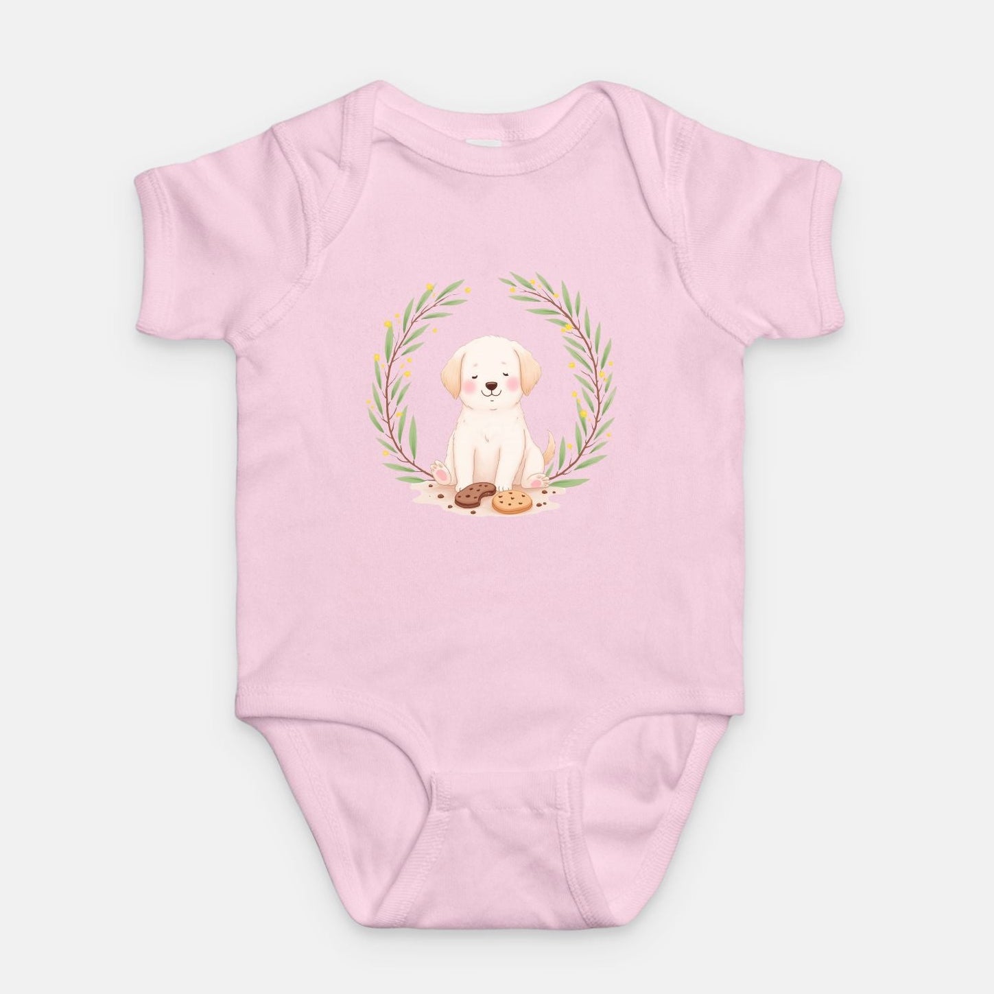Little Chaos Crew puppy sitting with eyes closed surrounded by cookies and crumbs inside green leafy wreath, minimalist baby pink onesie design.