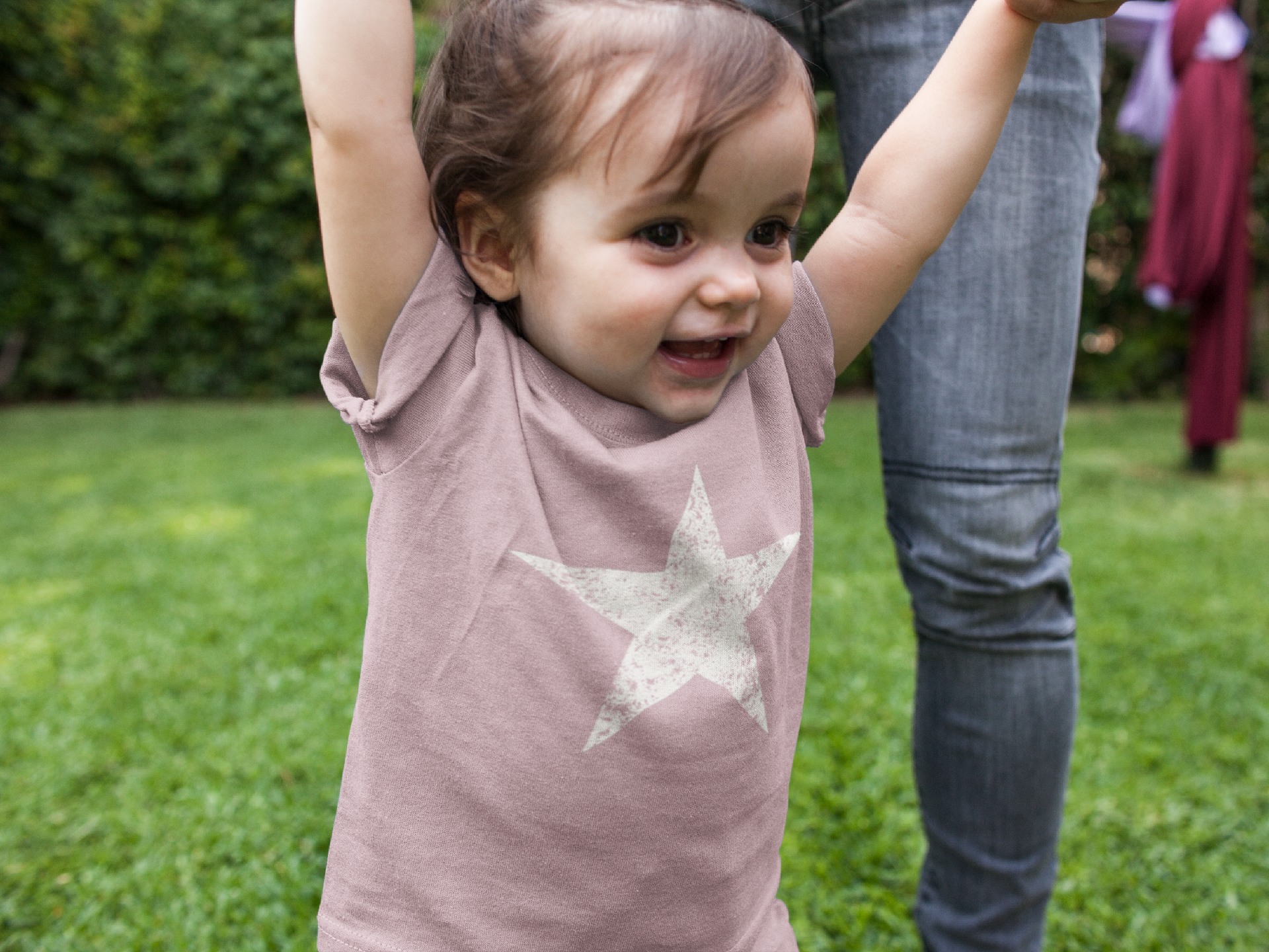 Child wearing a pink shirt with a star design outdoors